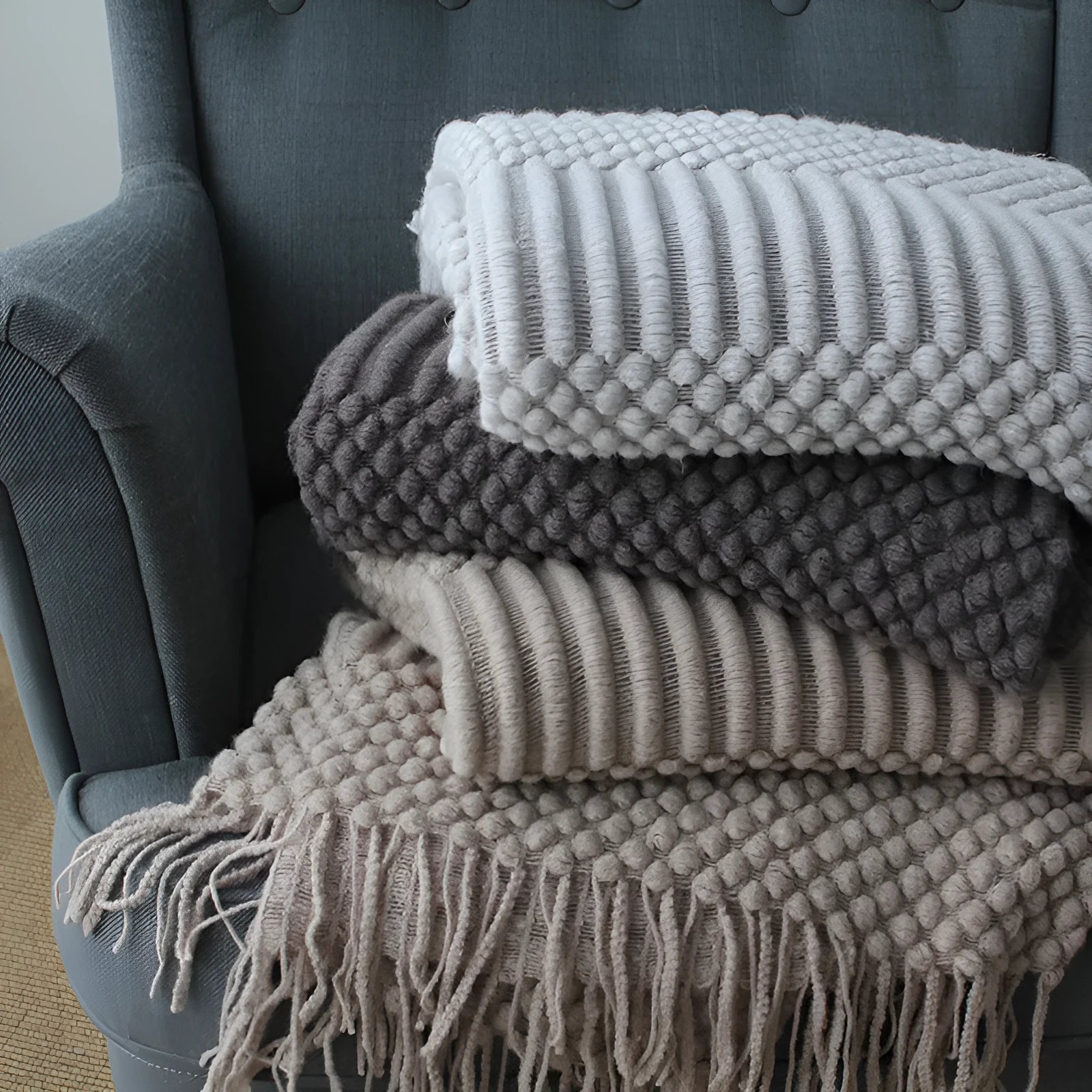 Small rectangular polyester nap blanket in dark grey, khaki, or light grey, shown flat with dimensions 127cm by 170cm.