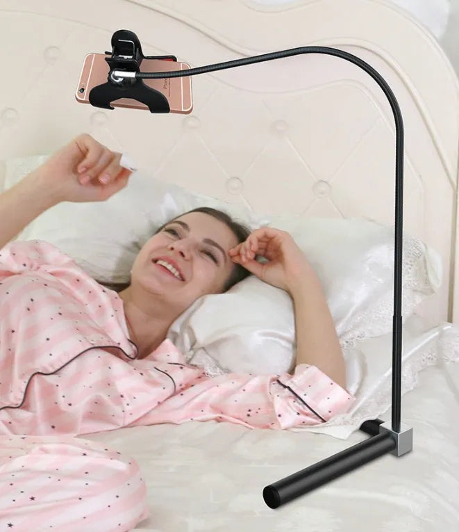 Black mobile phone bed bracket with overhead shelf mounted beside bed for hands-free viewing