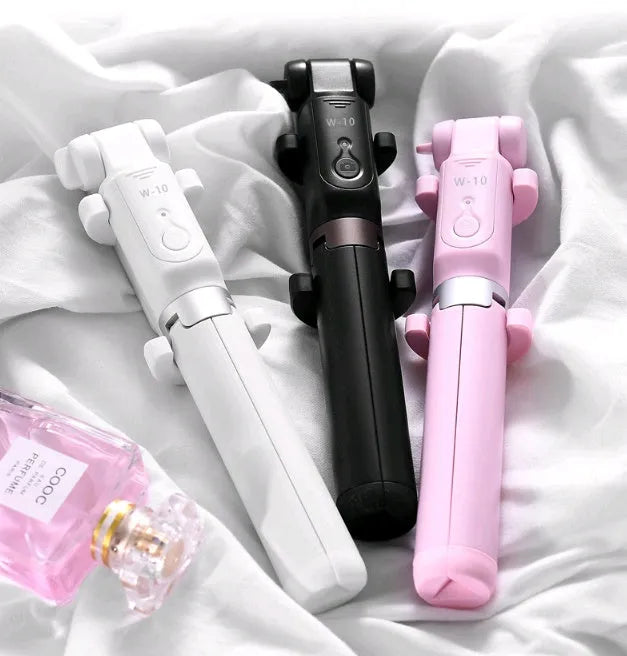 Bluetooth selfie stick tripod with remote control extended with smartphone attached