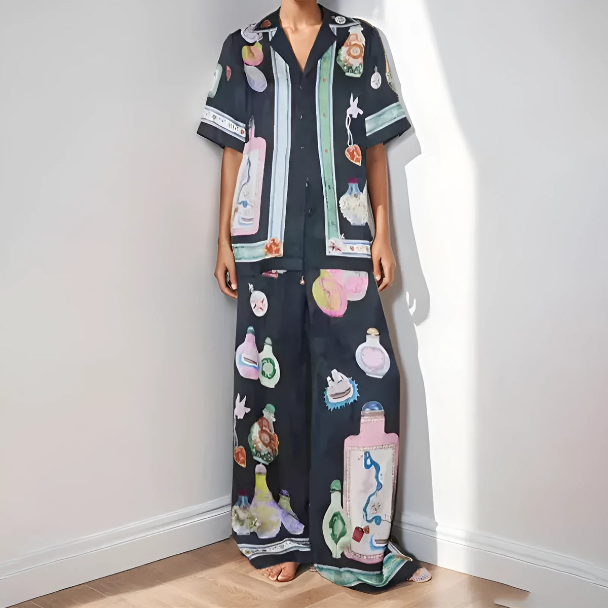 Women's black cardigan set with cartoon pattern, includes top and trousers