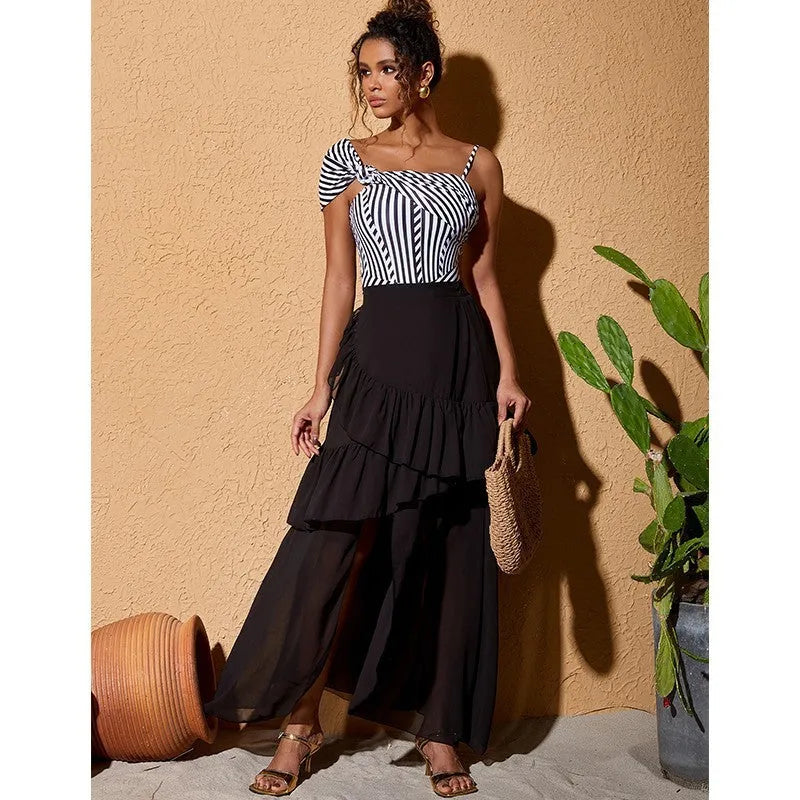 Women's striped one-piece swimsuit with ruffled detailing and black skirt attachment