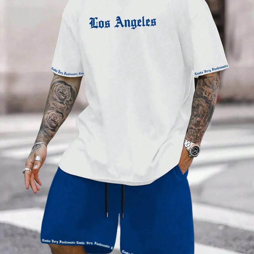 Man wearing a blue printed short-sleeved top and matching shorts from a sports-style two-piece set