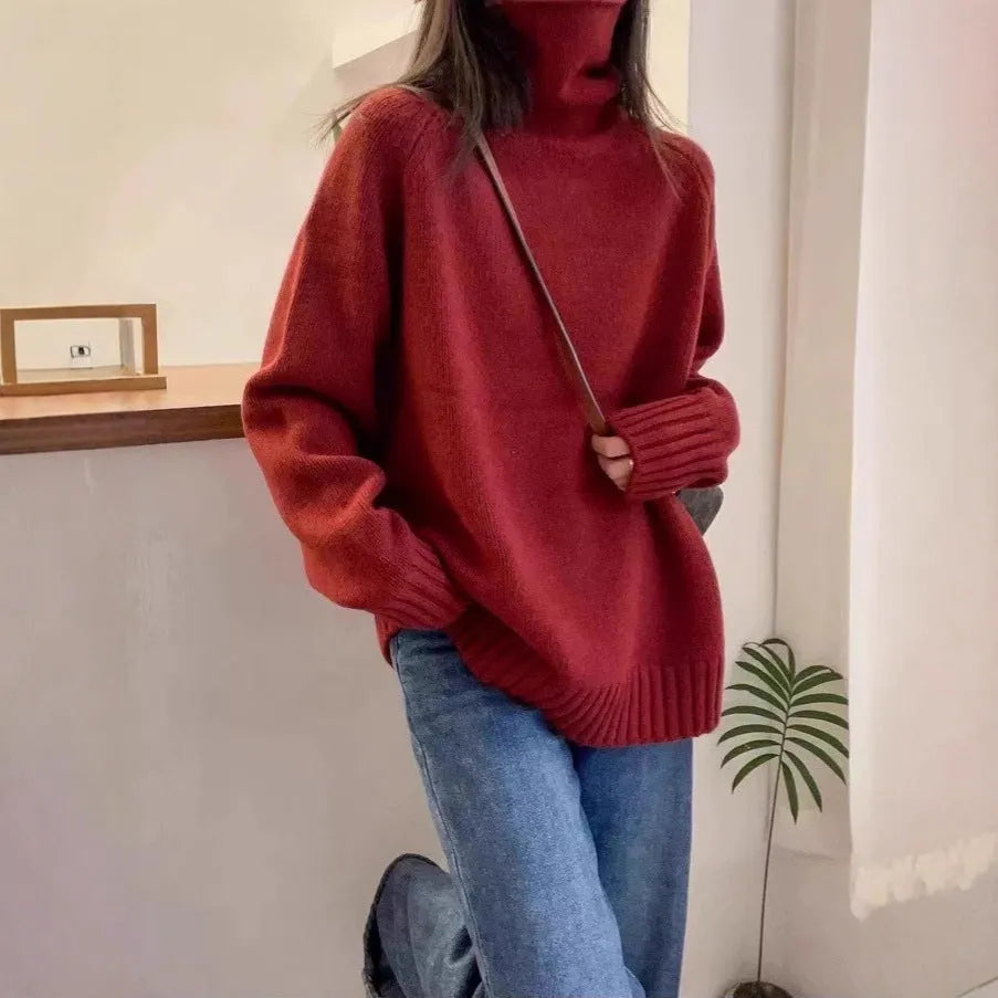 A woman's loose-fitting thick turtleneck sweater in a solid colour with a 3D textured pattern.