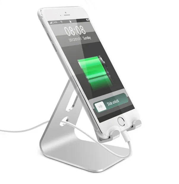 Metal universal phone and tablet stand in black, red, rose gold, and silver colours on a wooden table