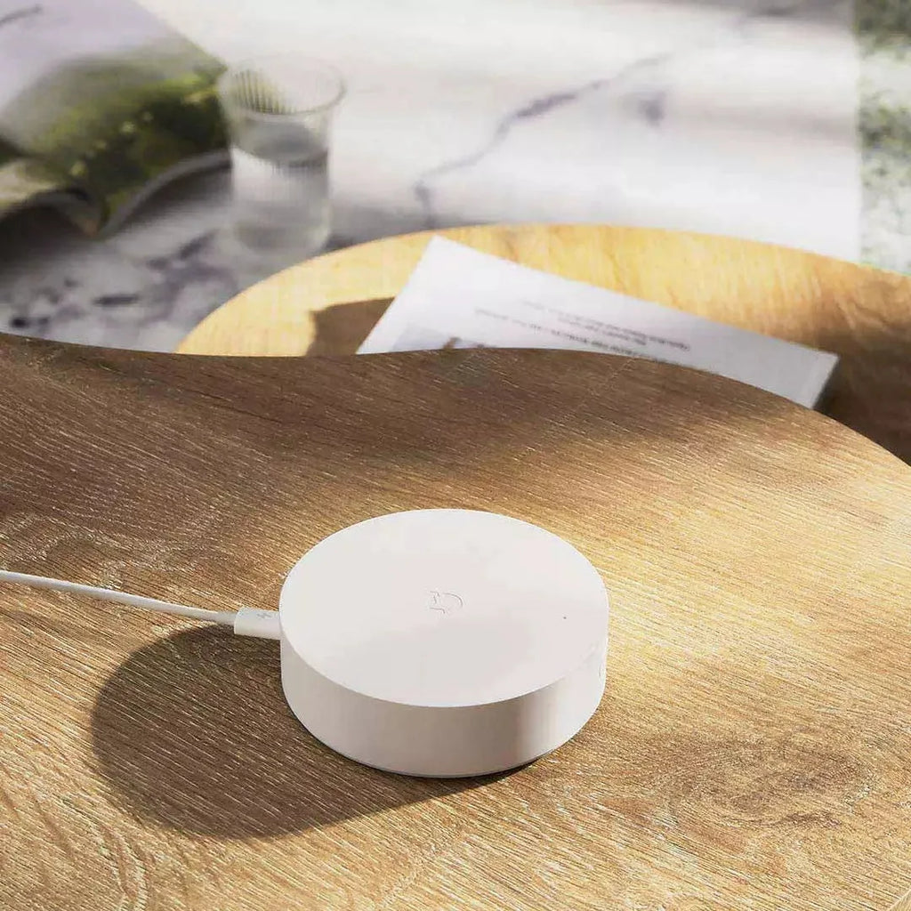 White Xiaomijia smart home gateway with UK plug, 90mm diameter, for wall mounting