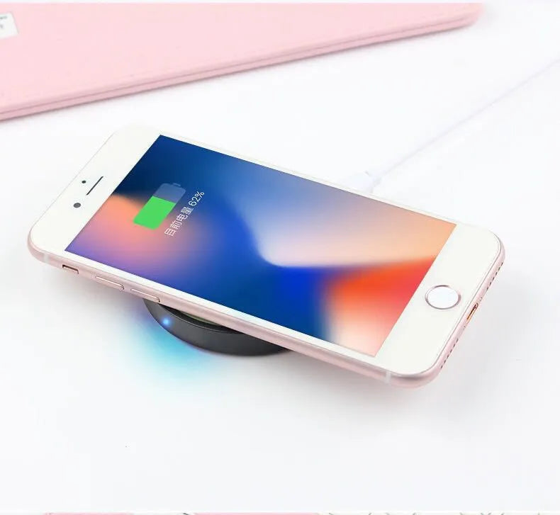 Square Qi wireless charging pad for mobile phones in six colour options on a desk.
