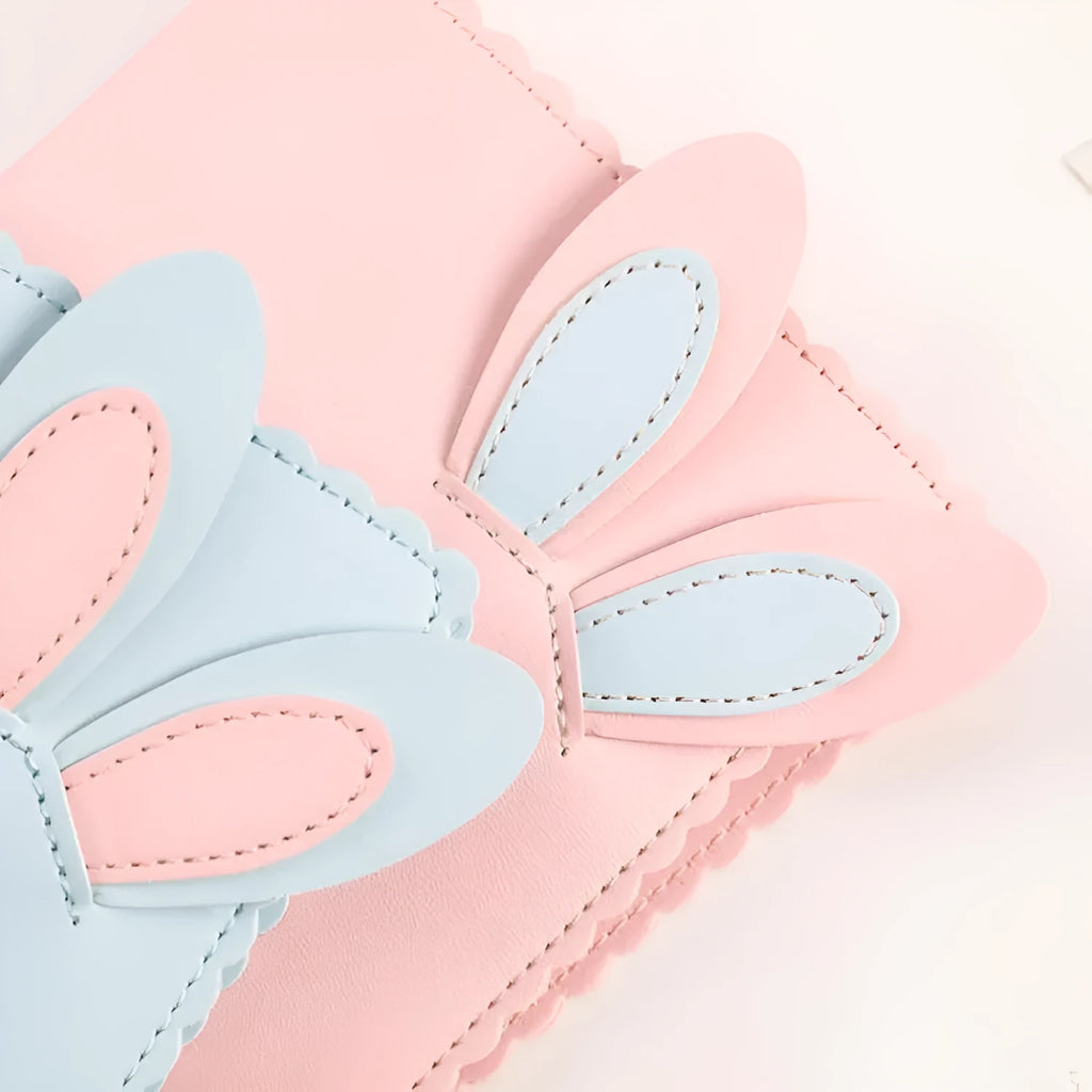 Cute bunny style mini photo album in blue, pink, or white, showing loose-leaf pages for 3-inch photos.
