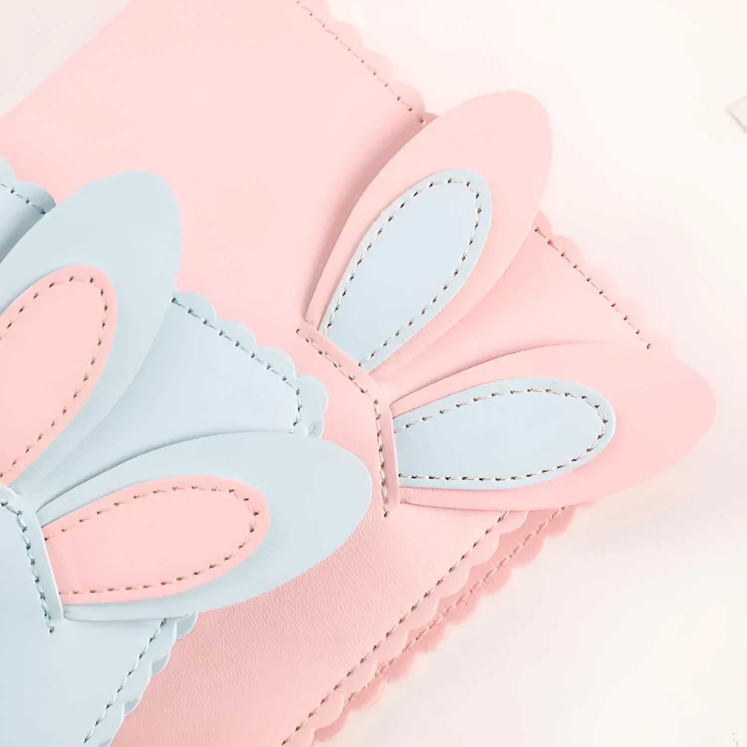 Cute bunny style mini photo album in blue, pink, or white, showing loose-leaf pages for 3-inch photos.