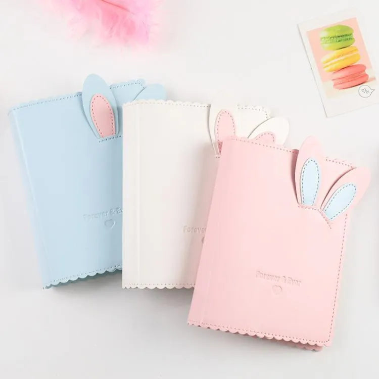 Cute bunny style mini photo album in blue, pink, or white, showing loose-leaf pages for 3-inch photos.