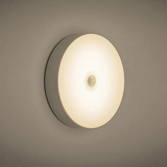 Small round beige or white LED night light with motion sensor and USB charging port