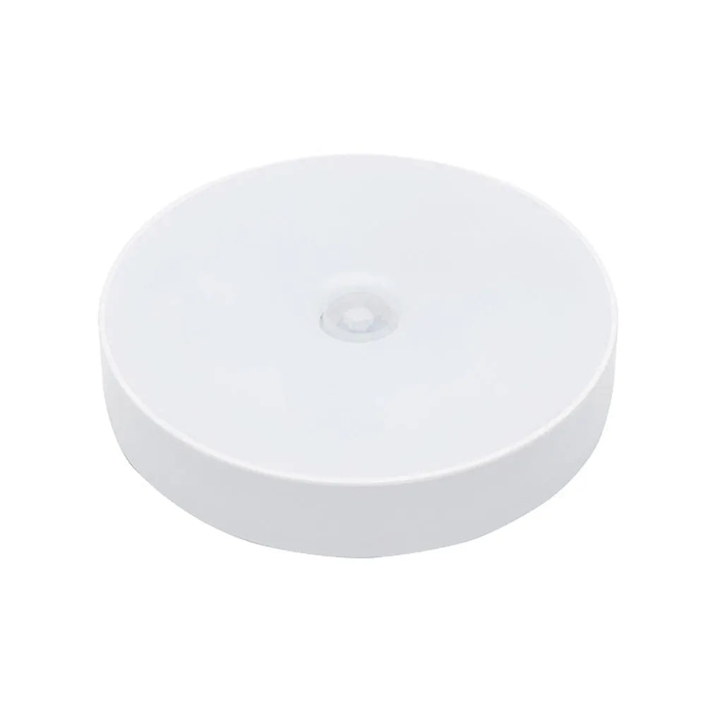 Small round beige or white LED night light with motion sensor and USB charging port