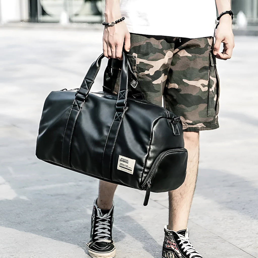 Black waterproof PU leather sports training bag showing internal organisation pockets and shoulder strap