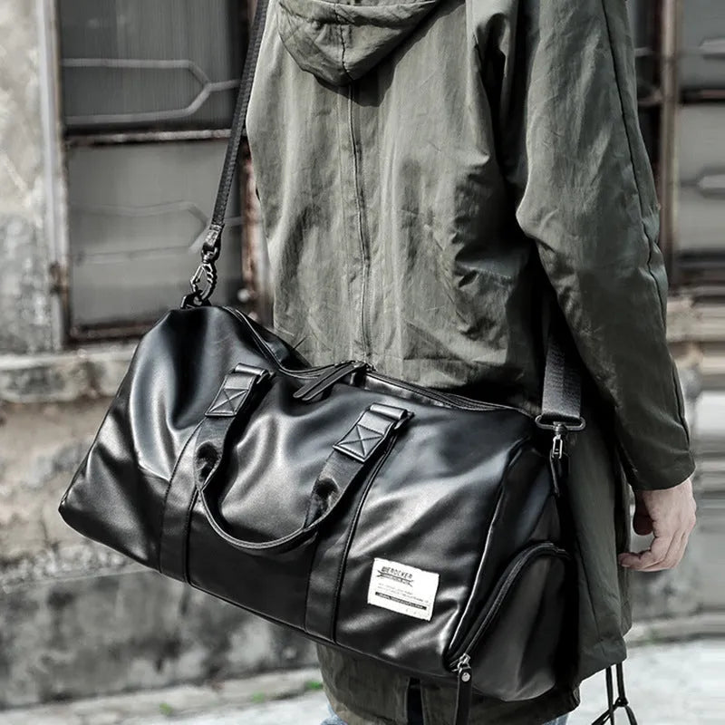Black waterproof PU leather sports training bag showing internal organisation pockets and shoulder strap