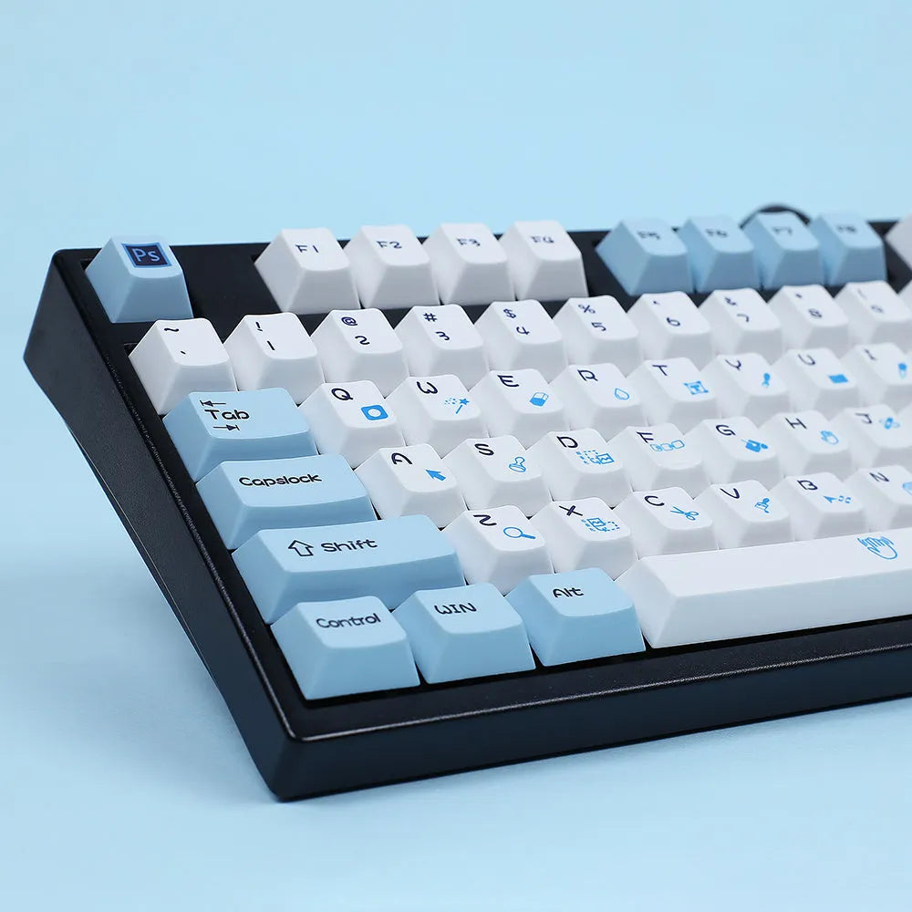 PlayStation-themed mechanical keyboard keycap set showing blue and white colourway with supplementary RGBK and CMYK keycaps