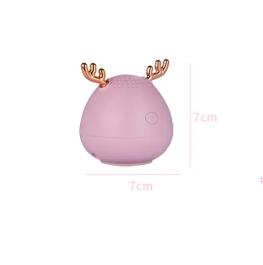Small white Bluetooth speaker measuring 75mm with USB charging cable