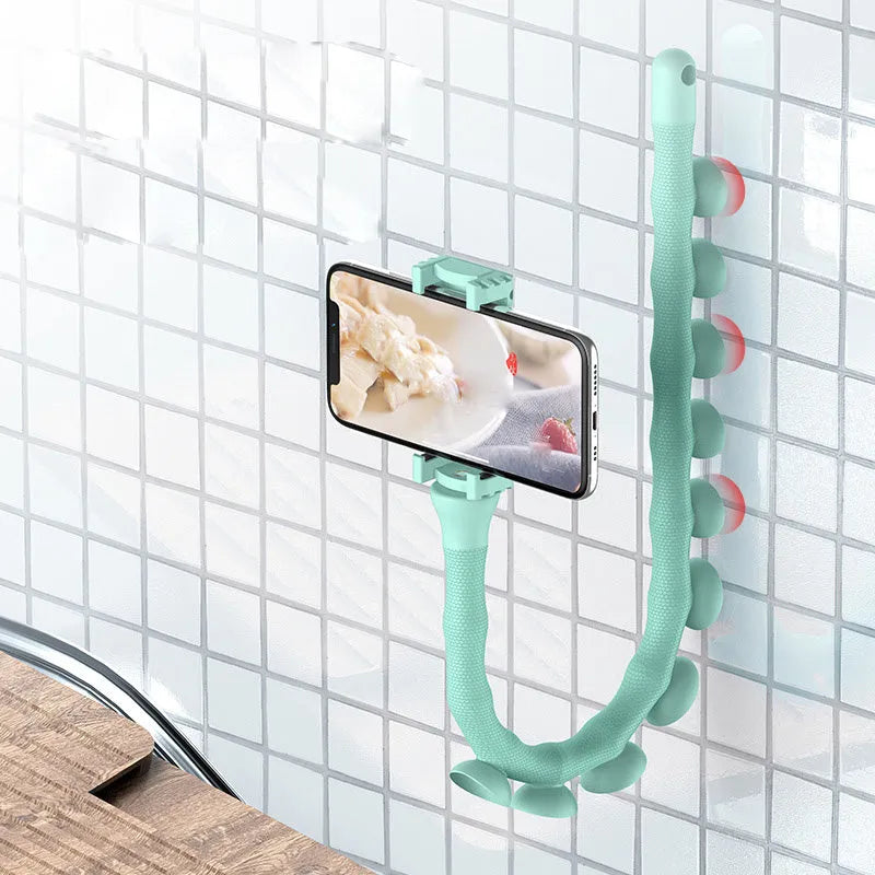 Flexible mobile phone holder with suction cup on desktop showing 360-degree rotation