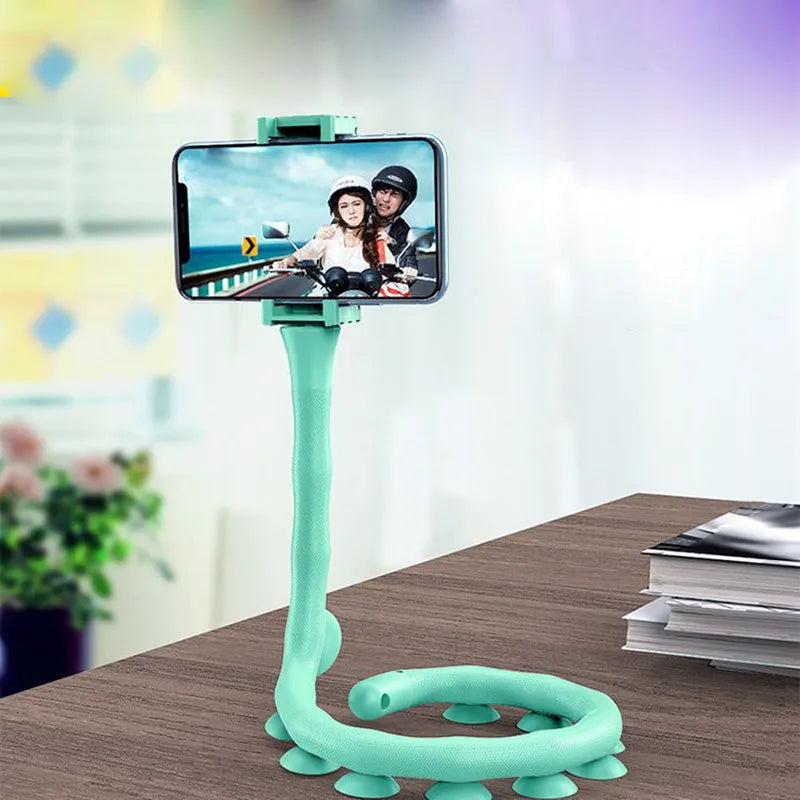 Flexible mobile phone holder with suction cup on desktop showing 360-degree rotation