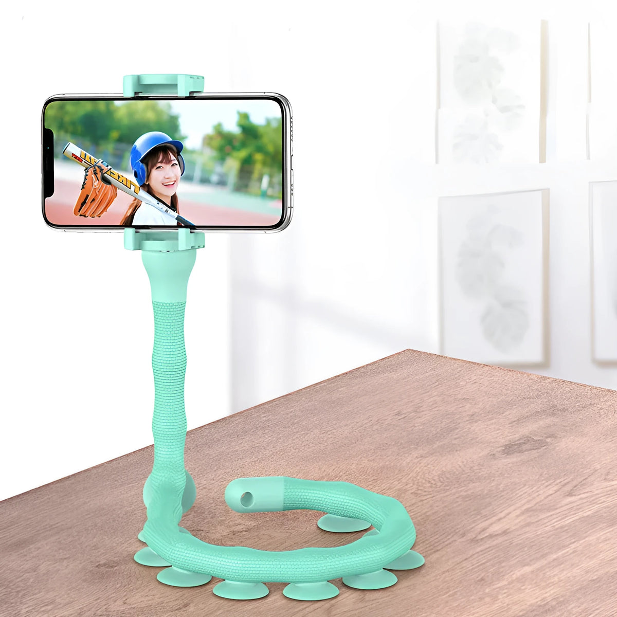Flexible mobile phone holder with suction cup on desktop showing 360-degree rotation