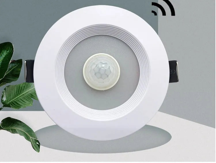 Aluminium recessed ceiling down light with infrared motion sensor for automatic white LED lighting.