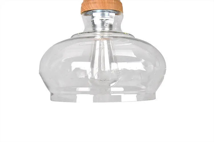 Nordic style single head pendant light with wood grain glass shade on an adjustable cable.