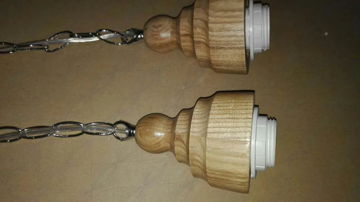 Nordic style single head pendant light with wood grain glass shade on an adjustable cable.