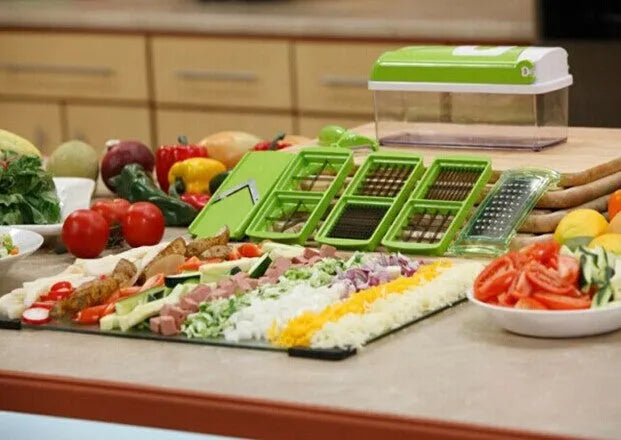 Green 12-piece manual food chopper set with stainless steel blades on a kitchen counter.