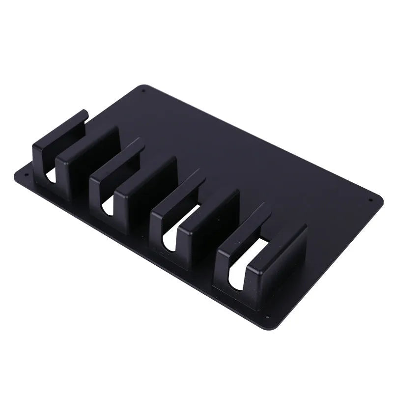 Black plastic wall-mounted rack holding four electric hair clippers