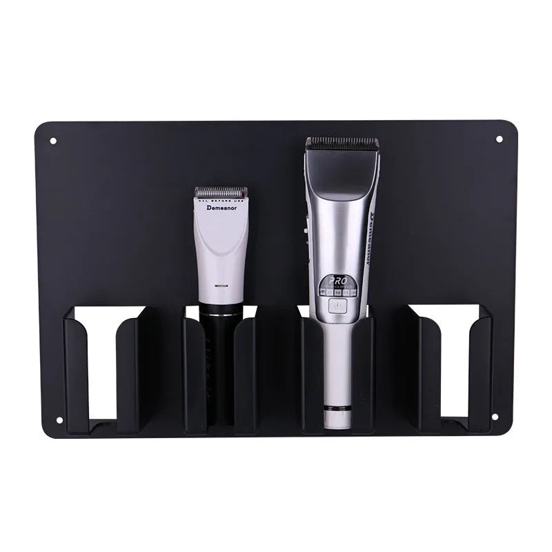 Black plastic wall-mounted rack holding four electric hair clippers