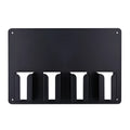 Black plastic wall-mounted rack holding four electric hair clippers
