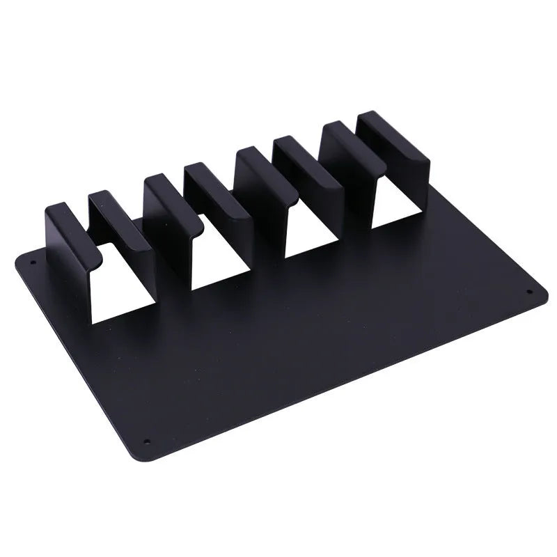 Black plastic wall-mounted rack holding four electric hair clippers