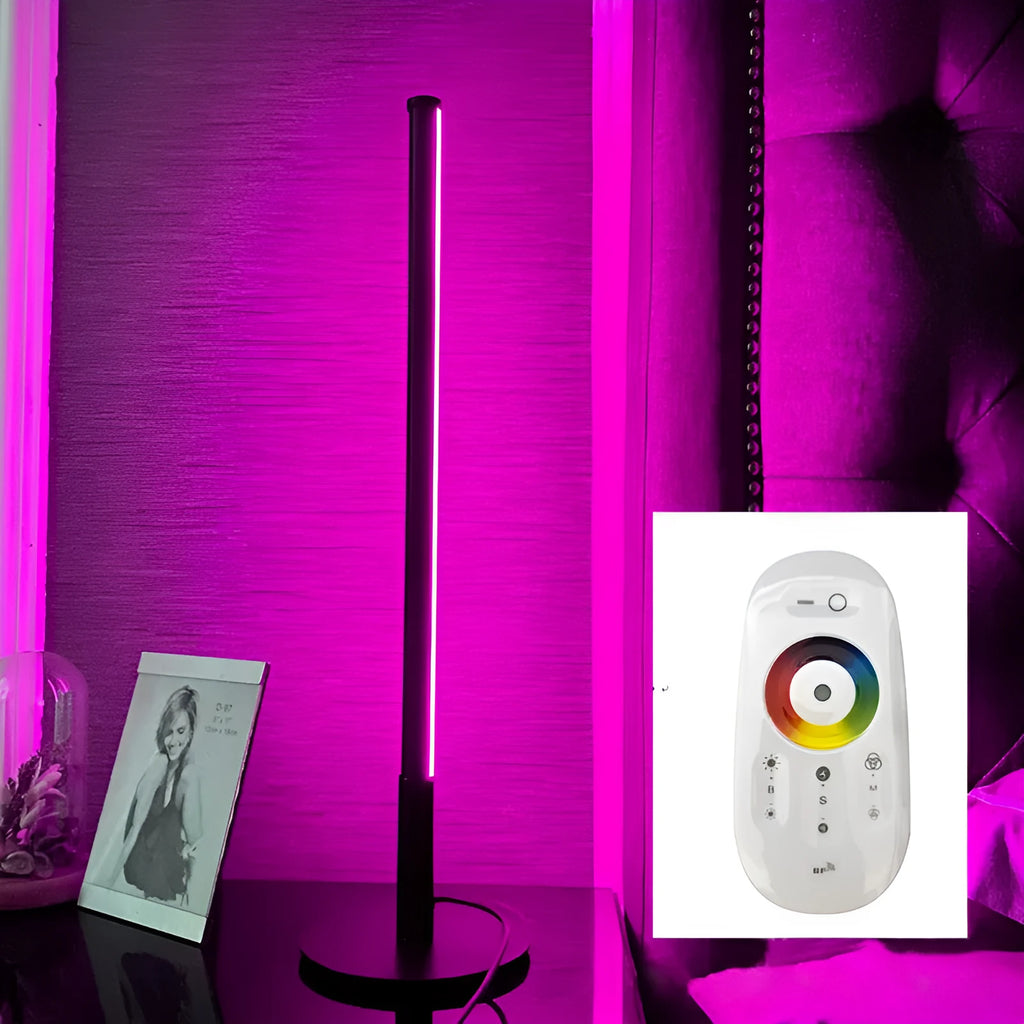 Tall black Nordic minimalist table lamp with RGB LED light on a wooden bedside table.