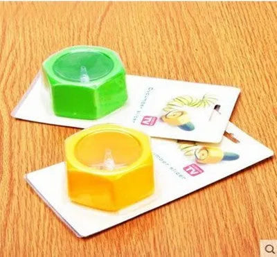 Yellow and green plastic spiral knife vegetable cutter for slicing cucumbers, 8 cm diameter.