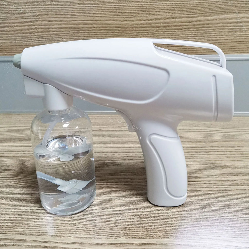 White handheld wireless electric spray gun for disinfection on a plain background.