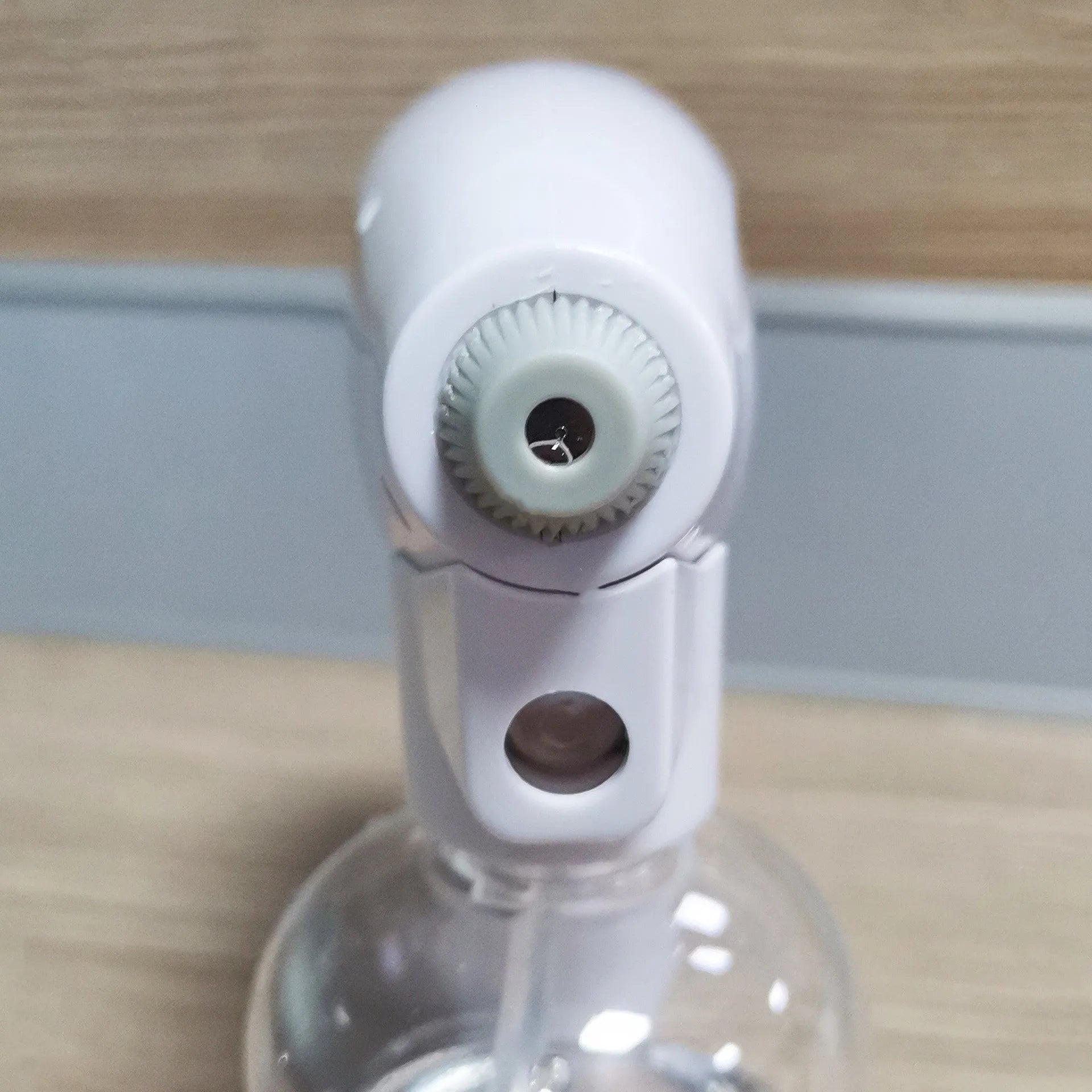 White handheld wireless electric spray gun for disinfection on a plain background.