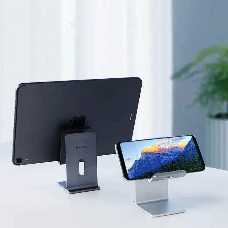 Alloy desktop mobile phone and tablet holder in dark gray or silver colour.