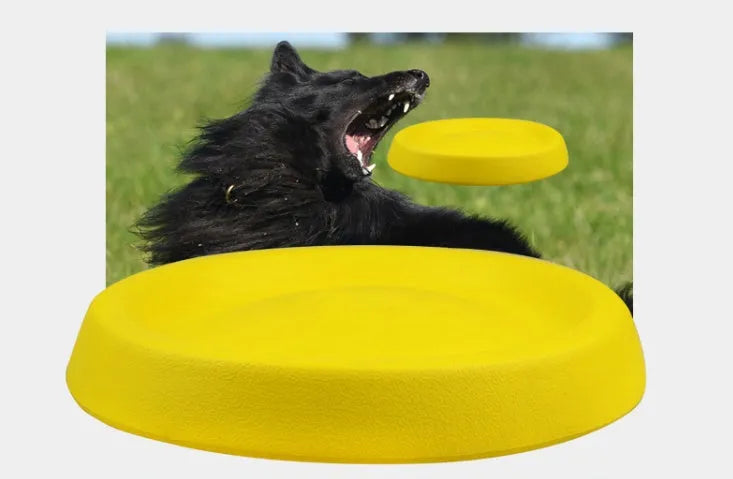 Yellow EVA plastic throwing toy for dogs on green grass
