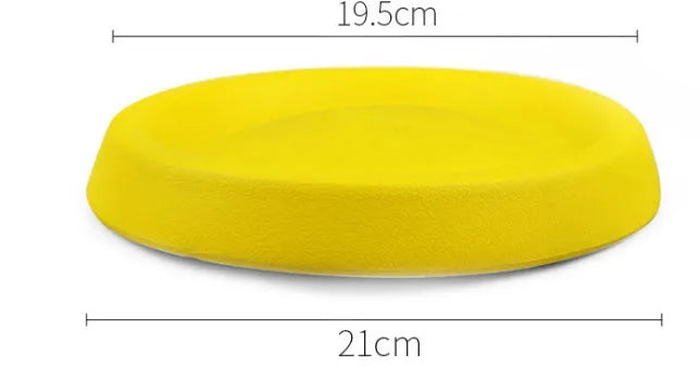 Yellow EVA plastic throwing toy for dogs on green grass
