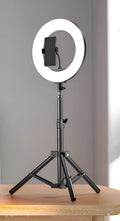 Carbon alloy mobile phone live tripod with mounted ring light and storage bag.