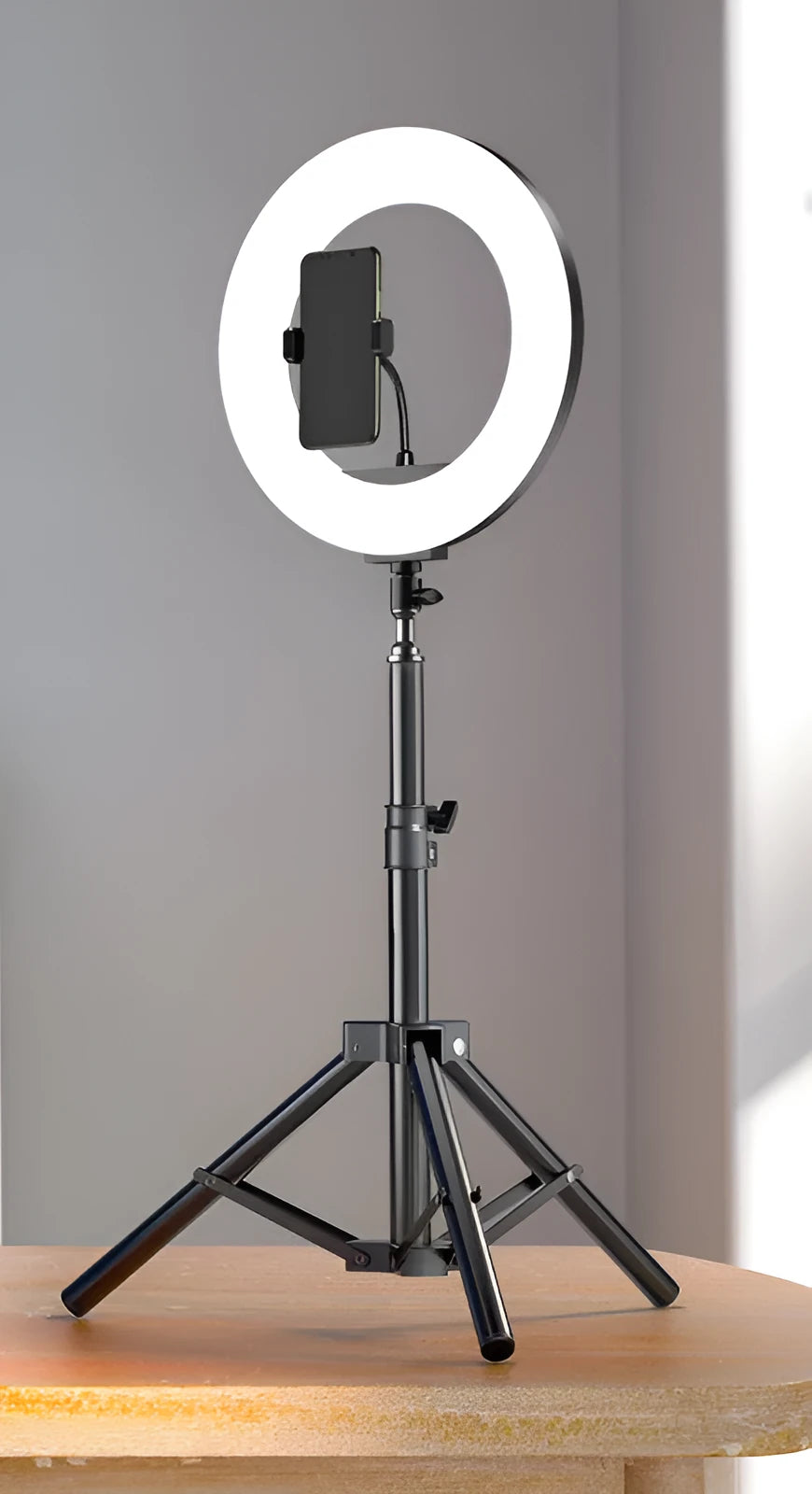 Carbon alloy mobile phone live tripod with mounted ring light and storage bag.