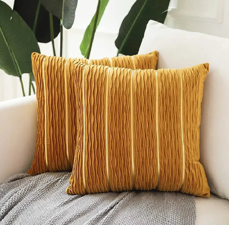 Square striped velvet plush cushion cover in a selection of colours on a sofa.