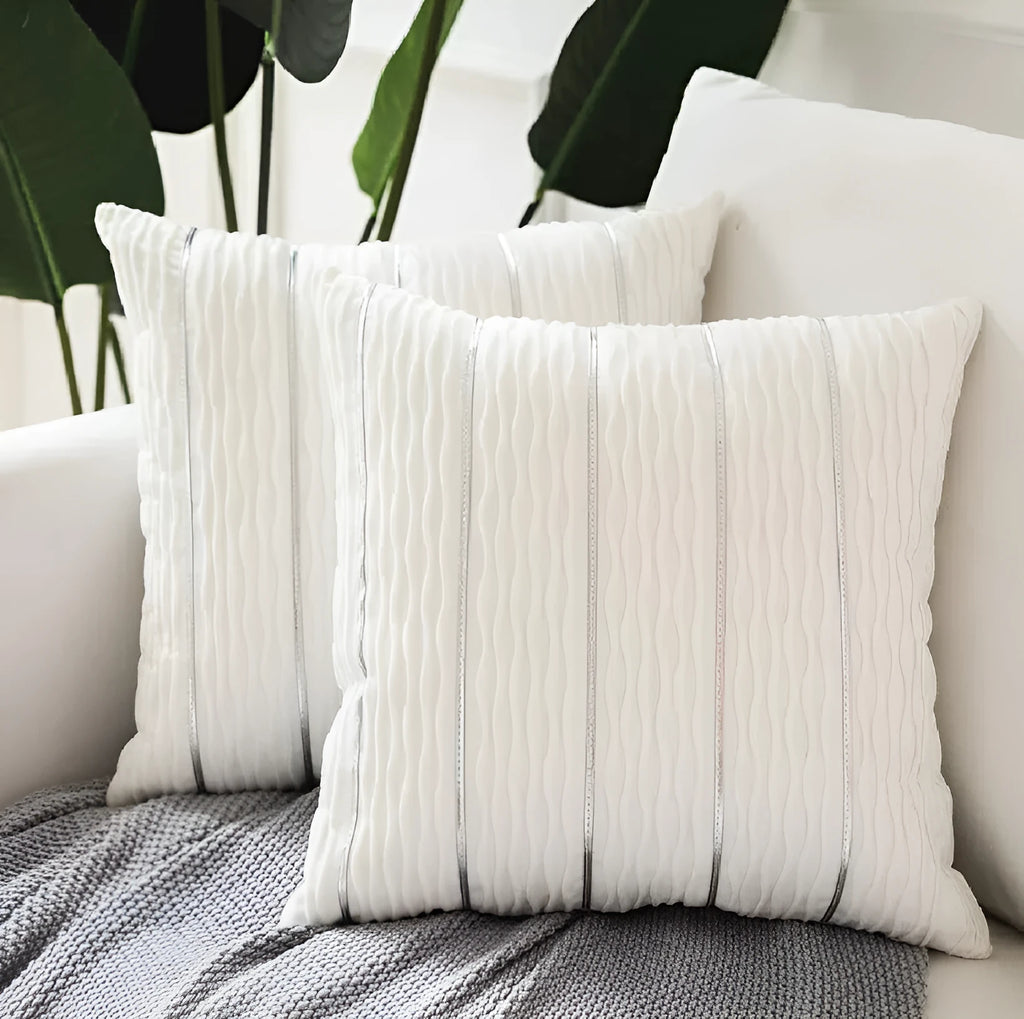 Square striped velvet plush cushion cover in a selection of colours on a sofa.
