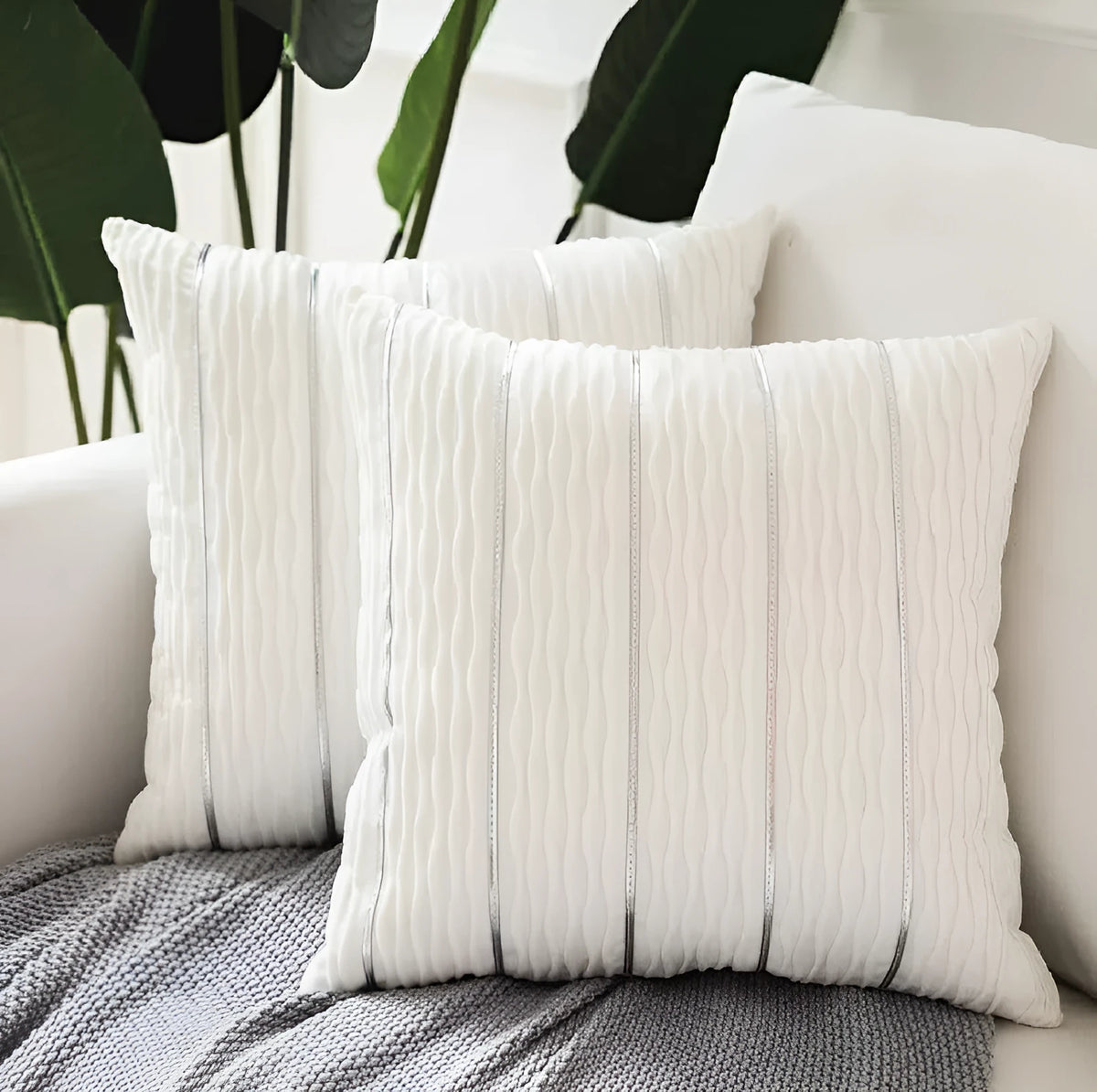 Square striped velvet plush cushion cover in a selection of colours on a sofa.