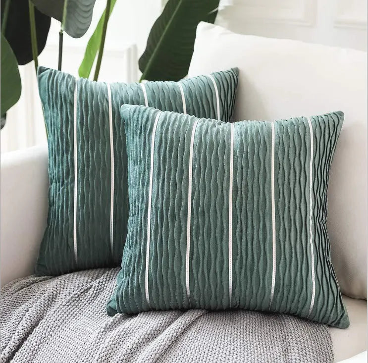 Square striped velvet plush cushion cover in a selection of colours on a sofa.