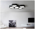 Geometric shaped LED light fixture with iron shade in black or white frame options