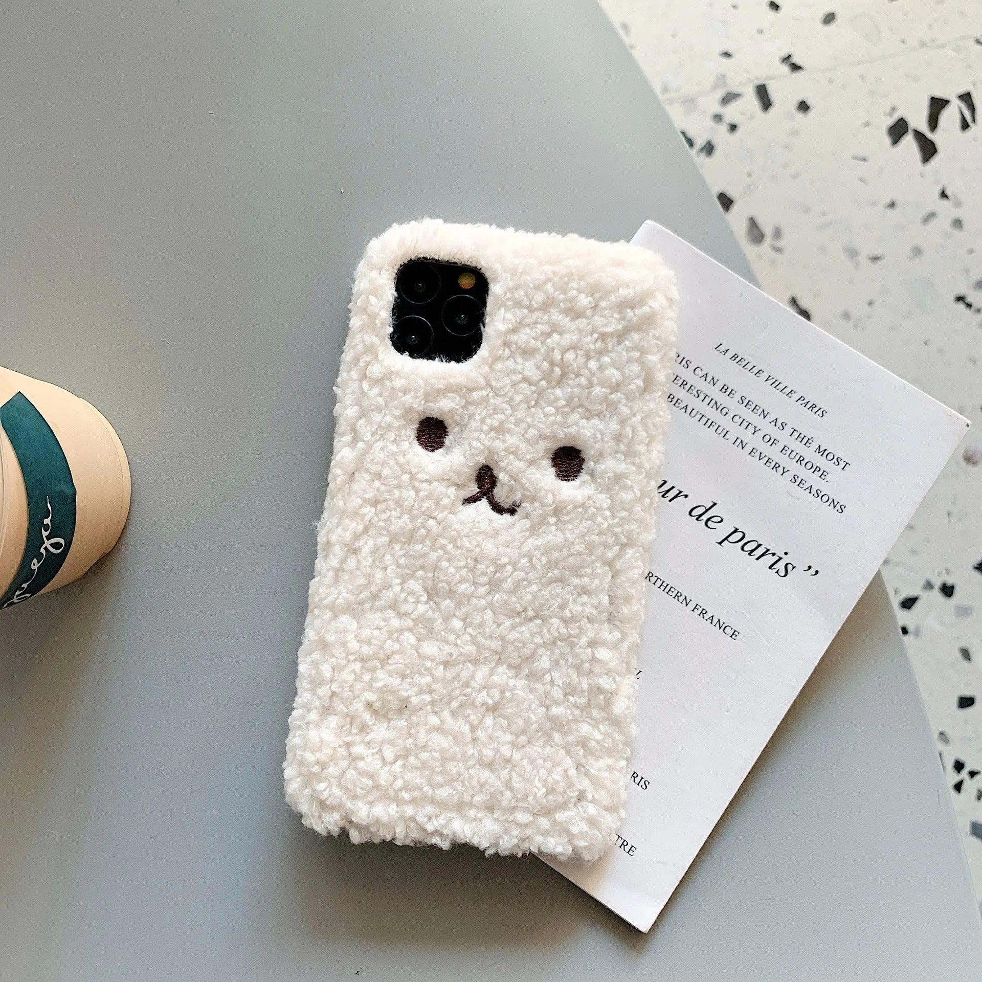 Brown embroidery plush cartoon bear face on a soft TPU iPhone case for iPhone 11.