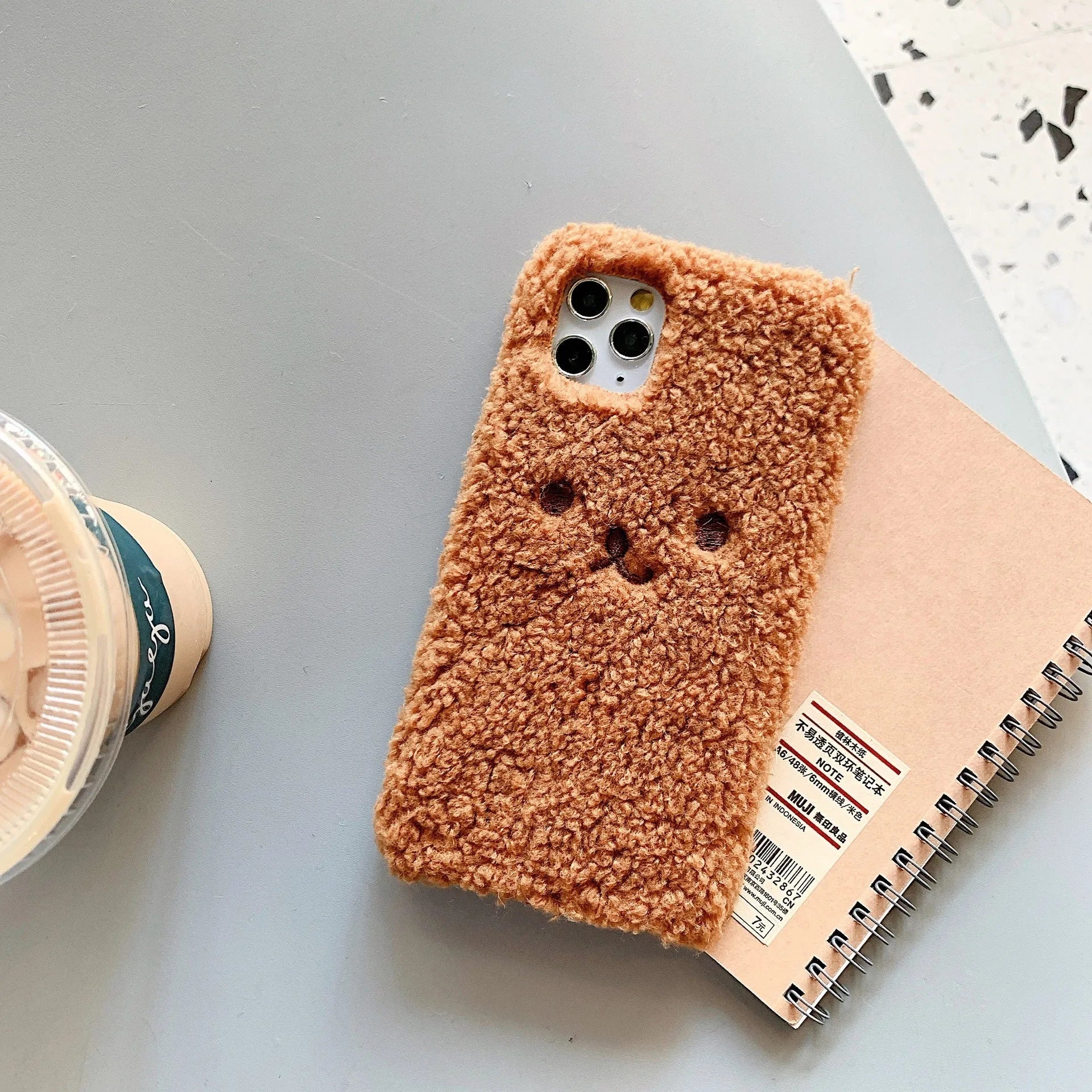 Brown embroidery plush cartoon bear face on a soft TPU iPhone case for iPhone 11.