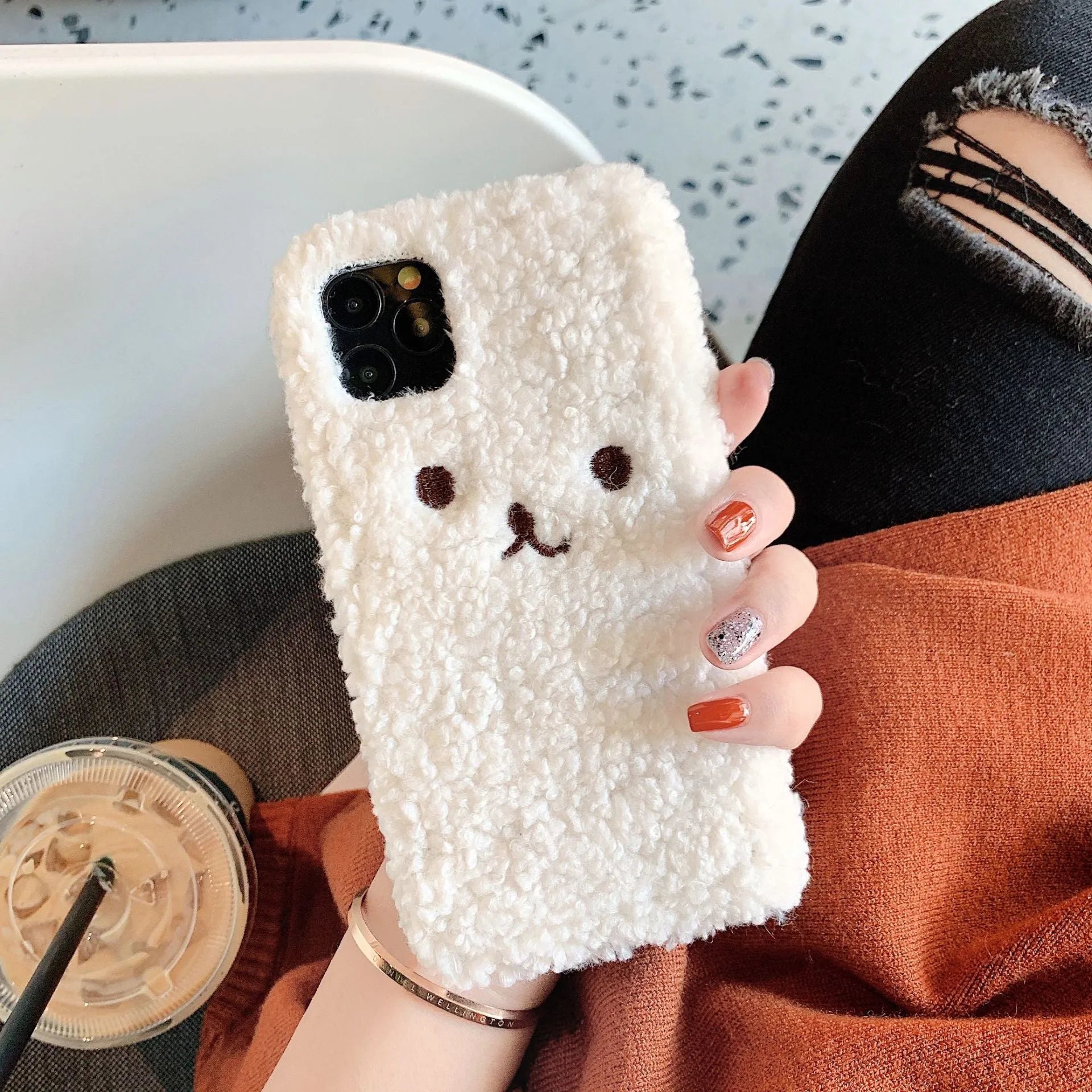 Brown embroidery plush cartoon bear face on a soft TPU iPhone case for iPhone 11.