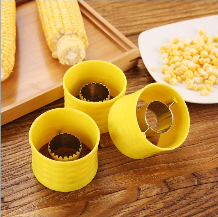 Yellow manual corn grinder thresher tool with corn-shaped design on a kitchen counter.