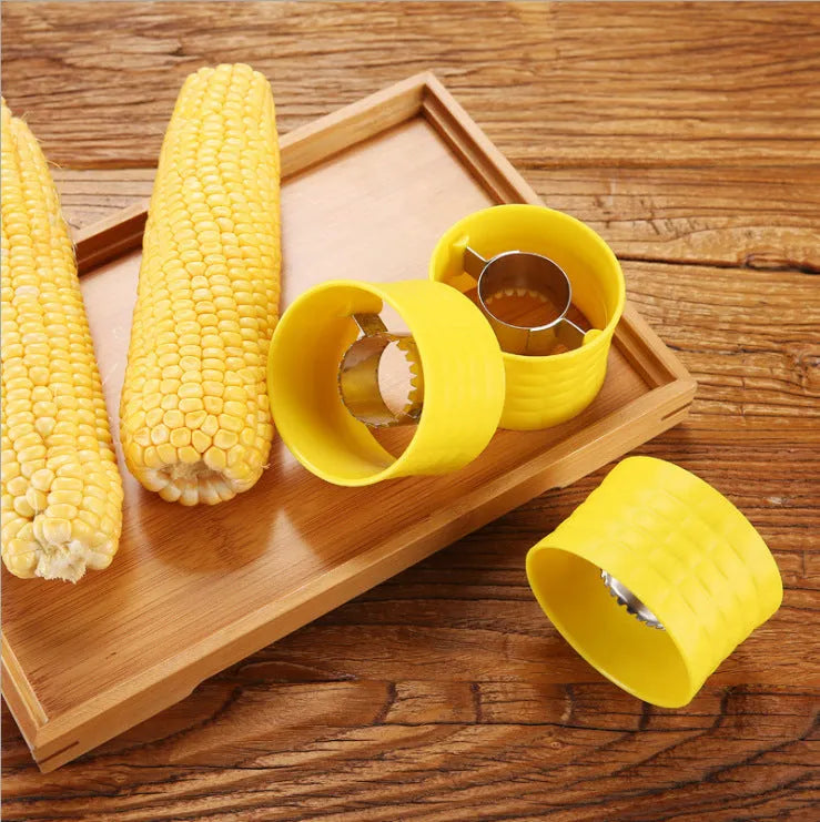 Yellow manual corn grinder thresher tool with corn-shaped design on a kitchen counter.