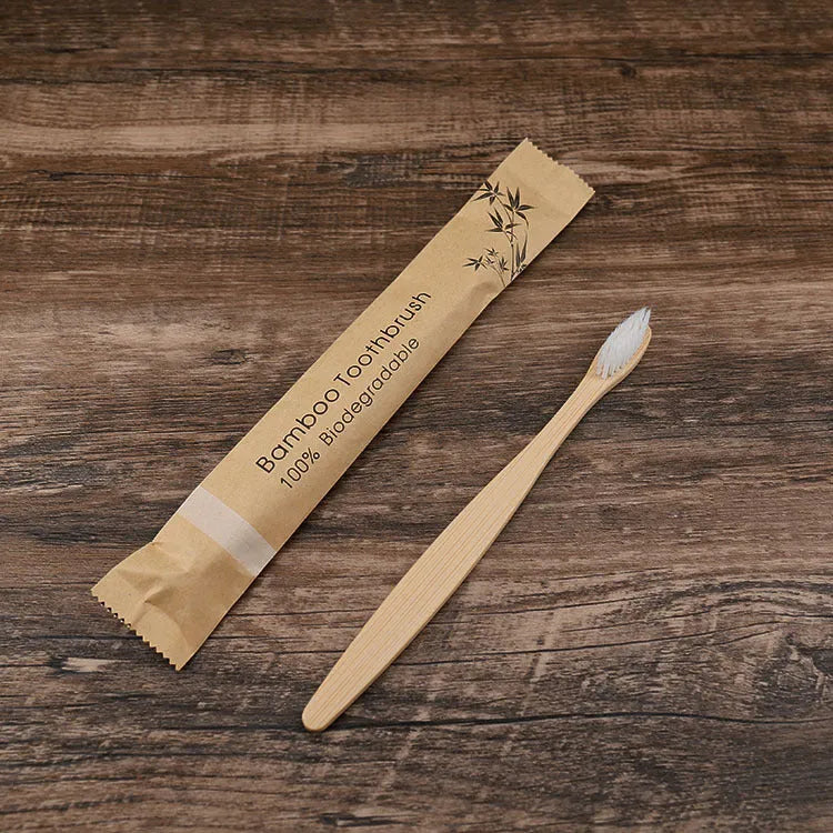 Ten bamboo toothbrushes with charcoal bristles in assorted colours on a white background.